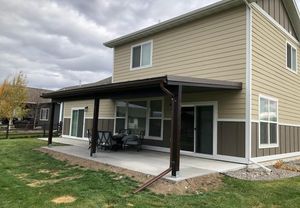 Backyard patio and metal pergola built by Hutch Construction