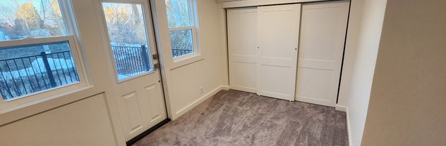Custom Interior doors and windows showing a custom closet built into an attic space and new doors and windows to a new deck on a roof. 
